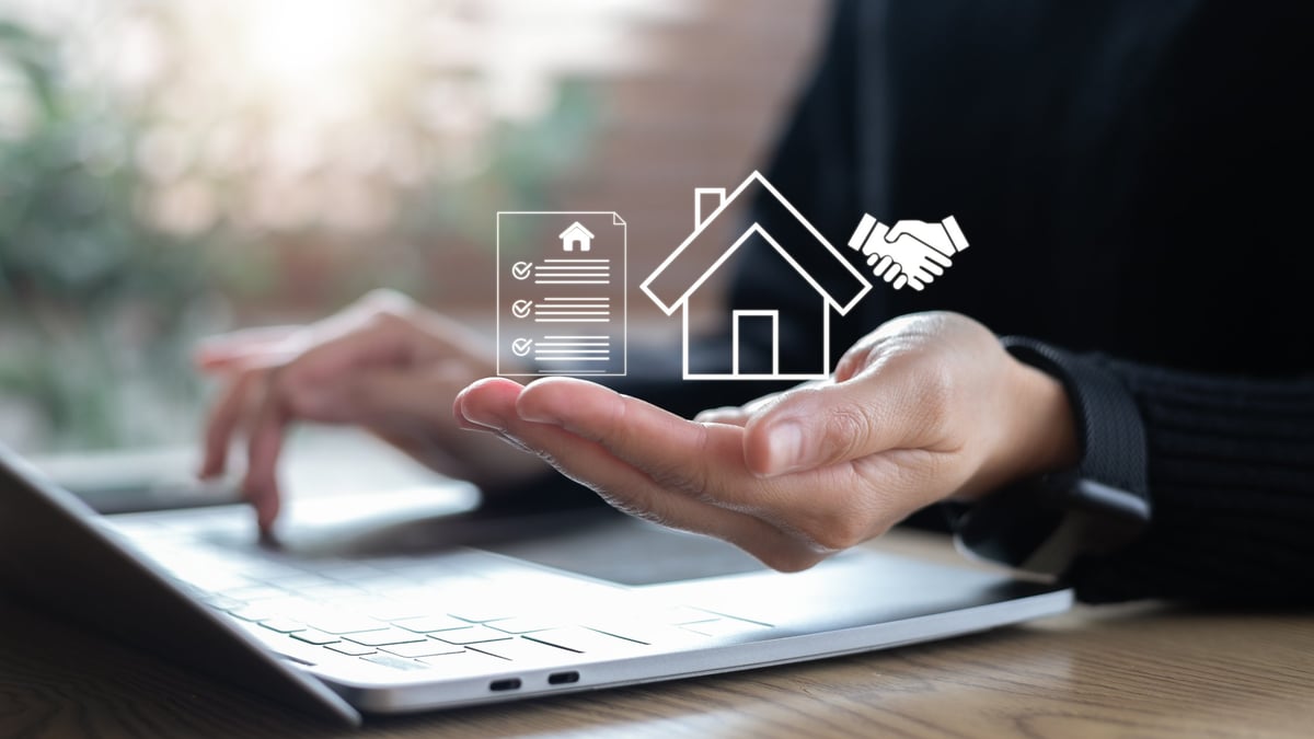Closeup hand holding digital house contract icon with handshake